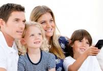 Smiling family watching a film at television Smiling family watching a film at television